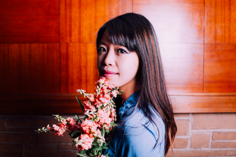 Jane Wong holds a bouquet of flowers. 