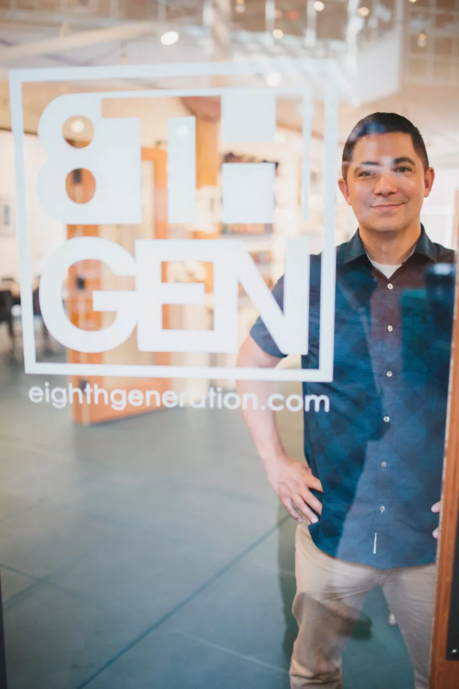 Louie Gong seen through the window of his Eight Generation store