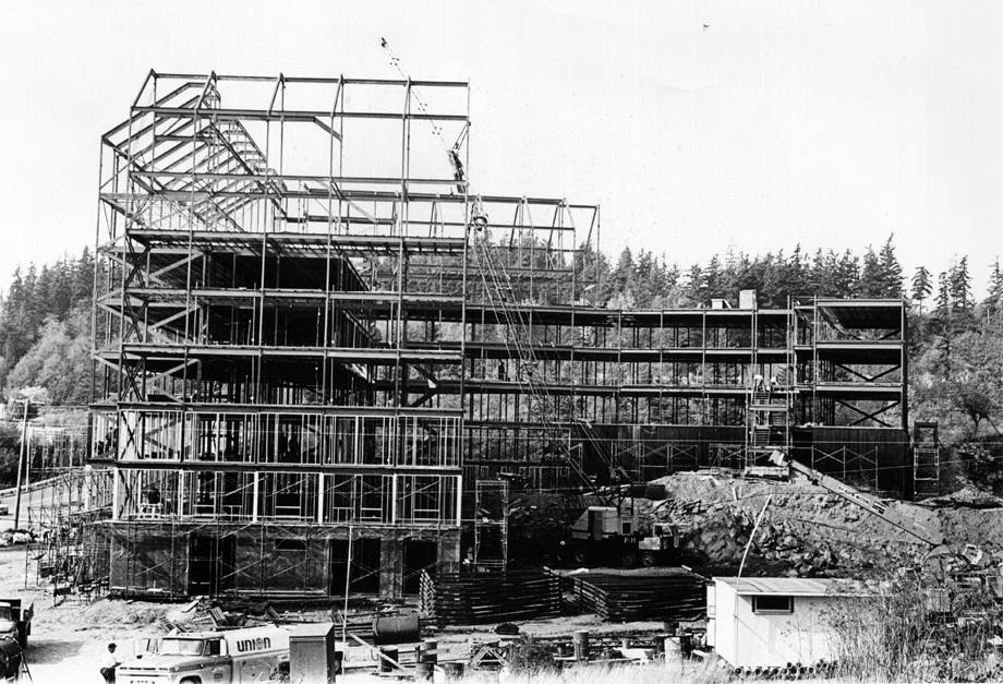 a black and white photo of a construction site shows the steel frame of Buchanan Towers 