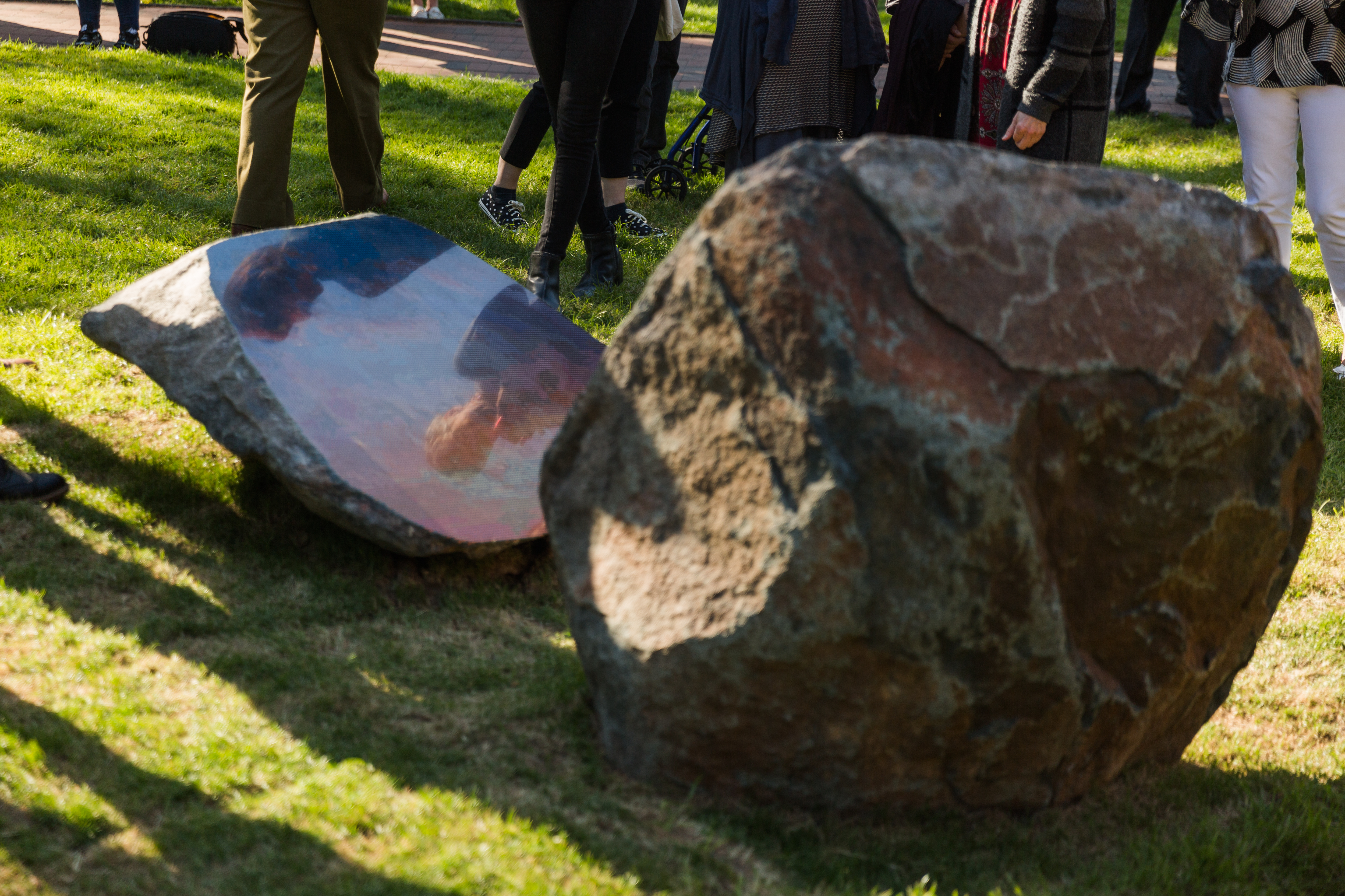 An etching of a sunset can be seen on the cut edge of a boulder on Sarah Sze&#039;s &quot;Split Stone (Northwest)&quot;