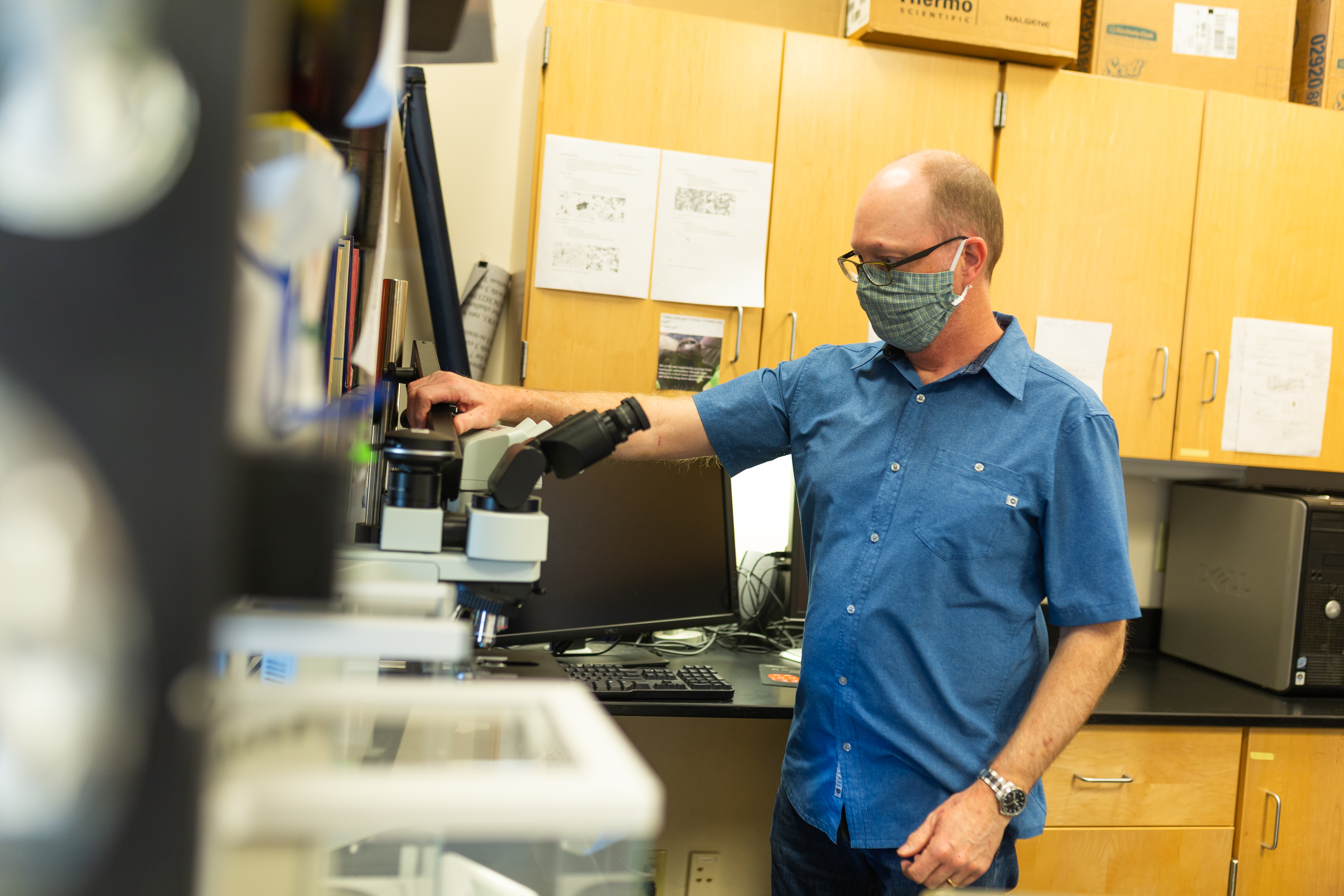 Jeff Grimm, wearing a mask, in his laboratory