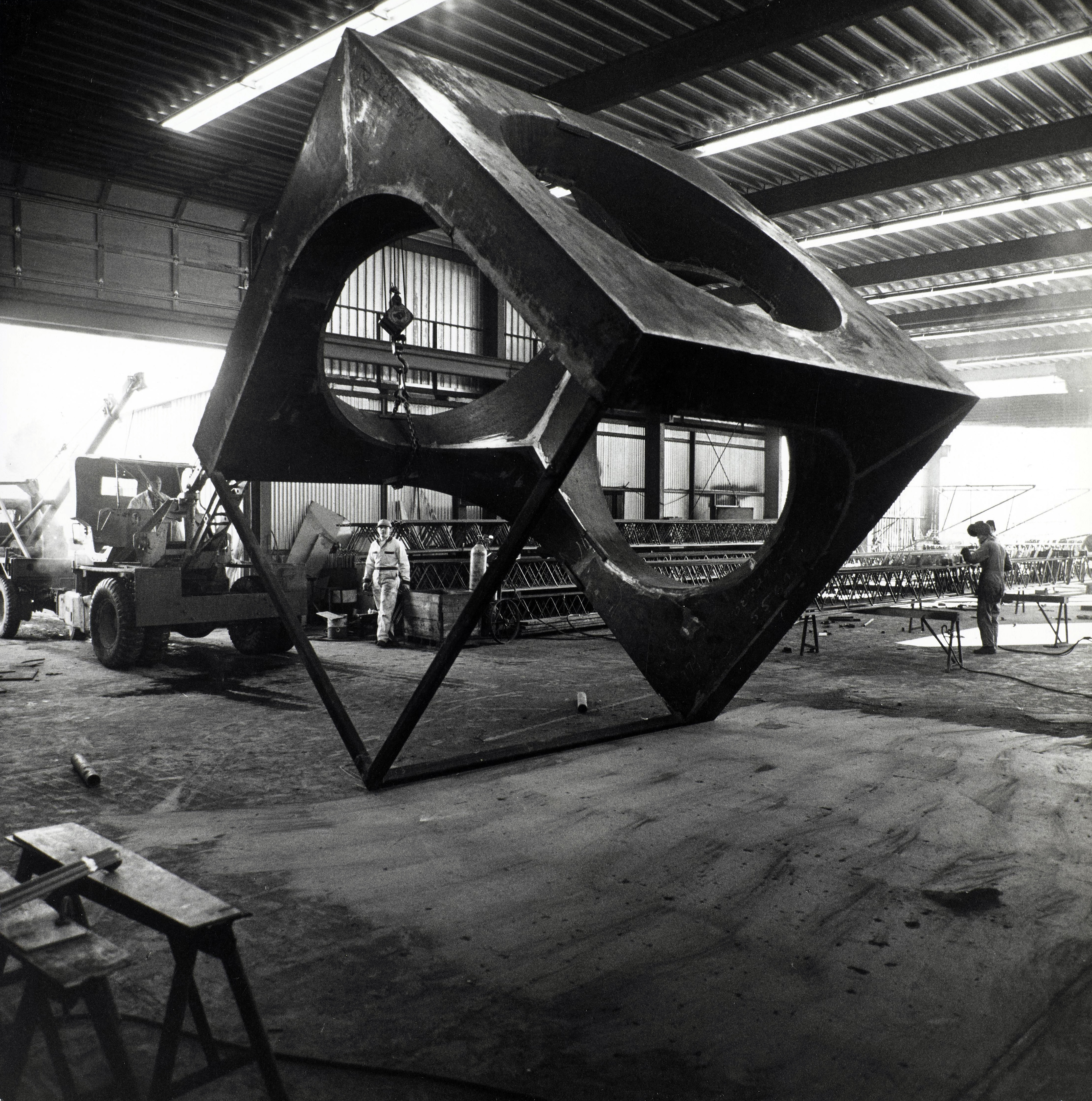 An unfinished Skyviewing sculpture hangs in a fabricating workshop
