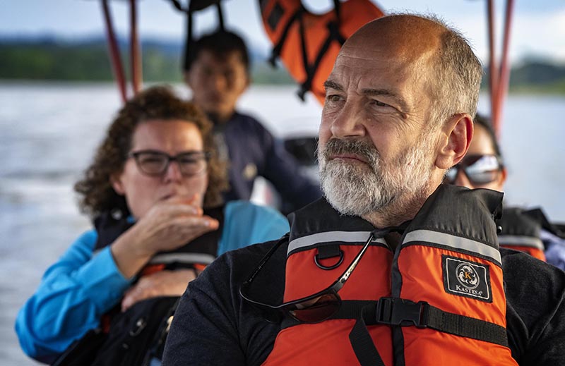 Story author John Thompson wearing a life jacket in the front of a boat, looking out onto the water