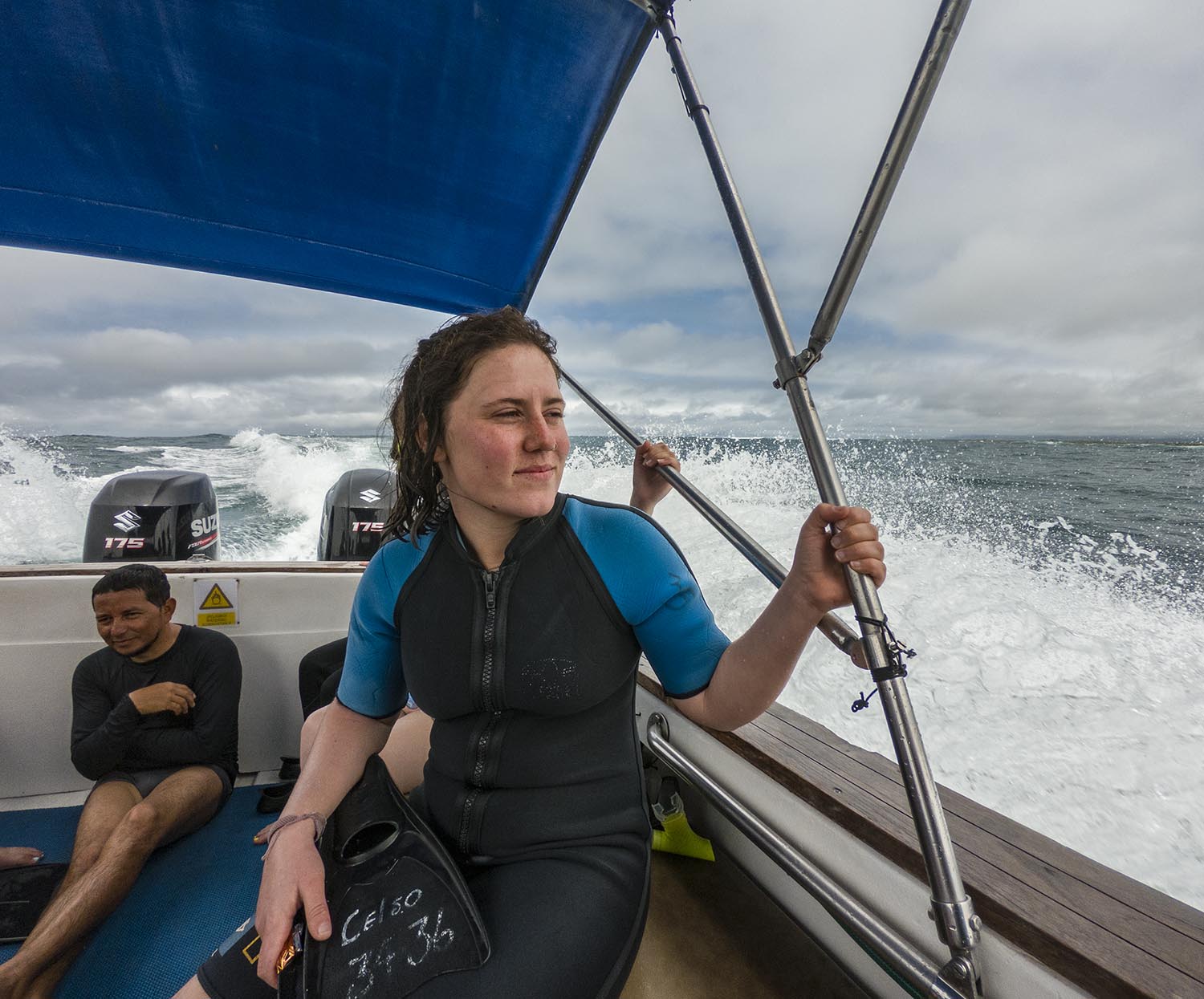 Collette Webb on a boat wearing a short sleeved wet suit