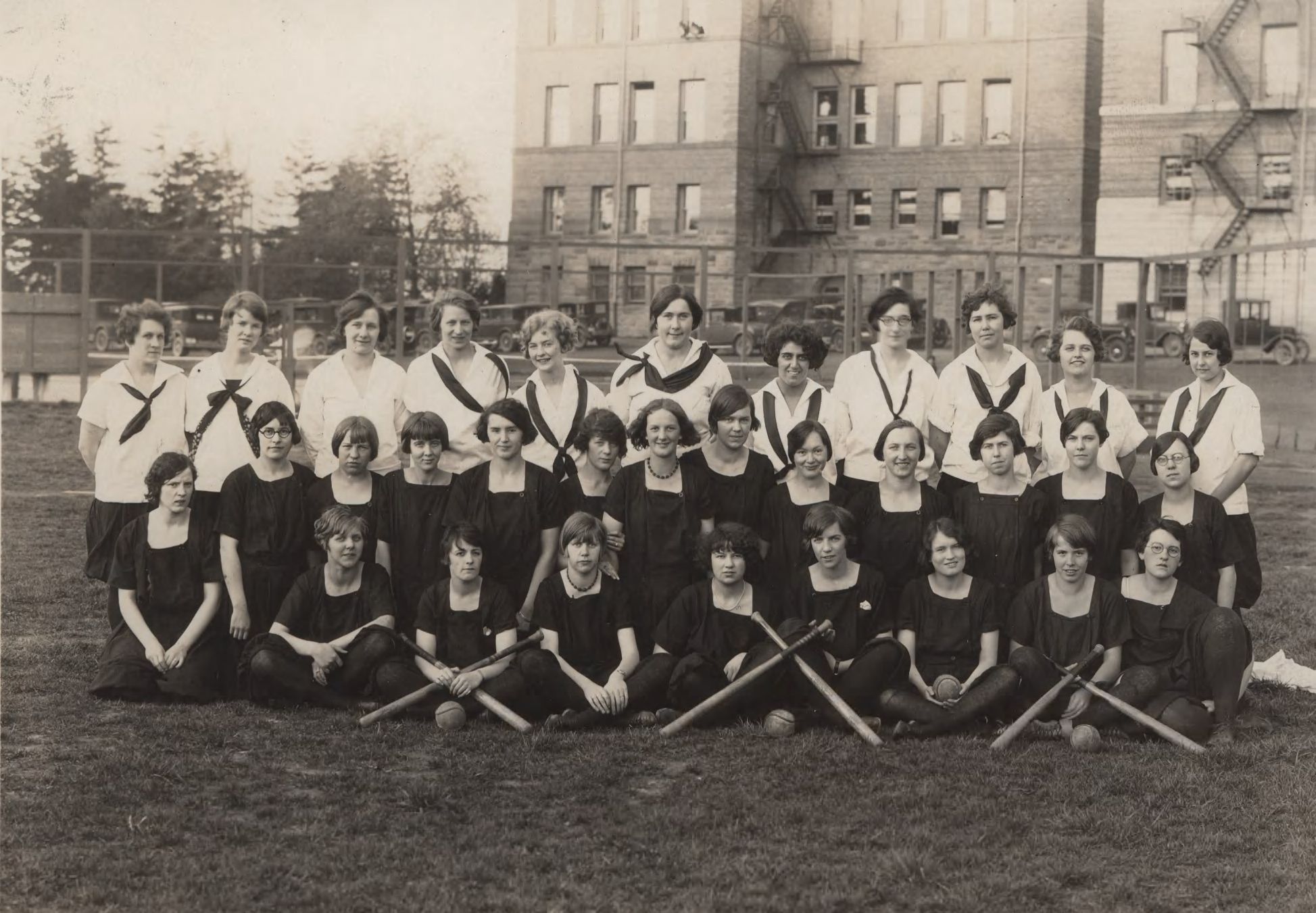 The women's baseball team gathers for a portrait near Old Main in 1927.