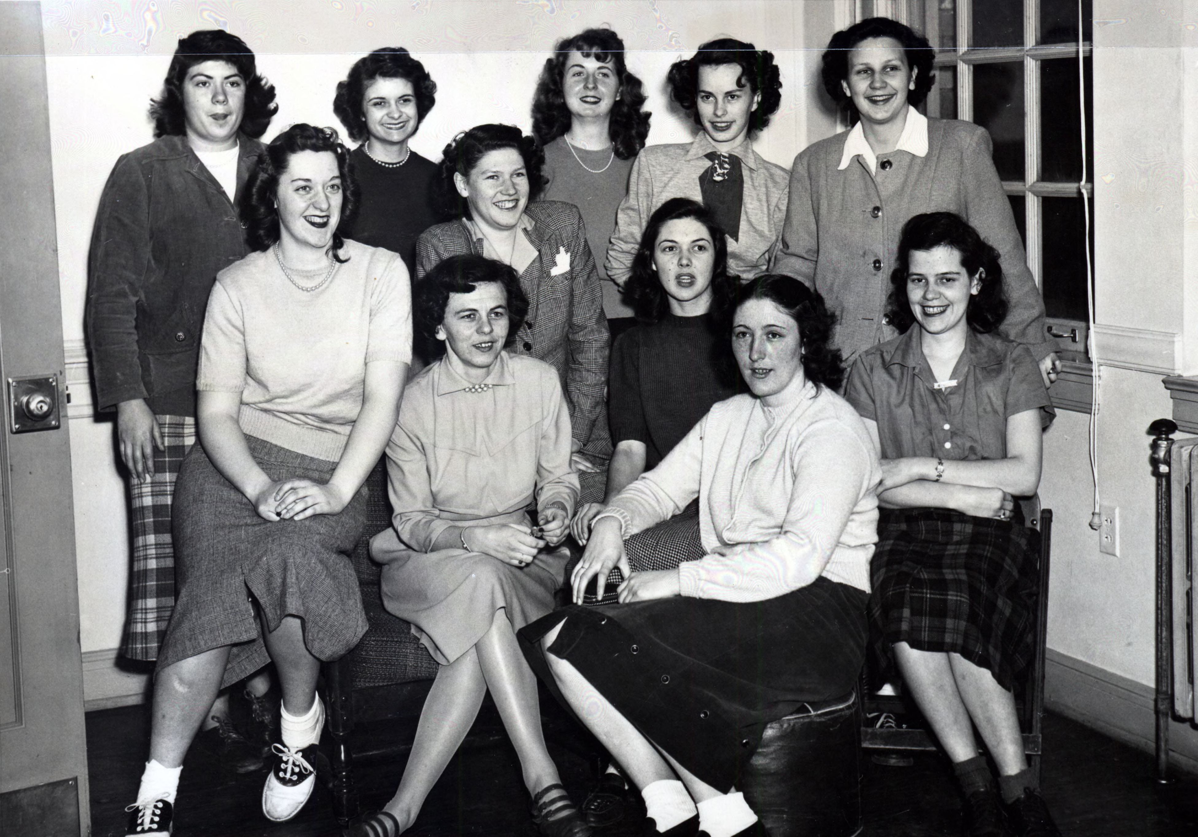 11 young women sit for a group portrait in 1948