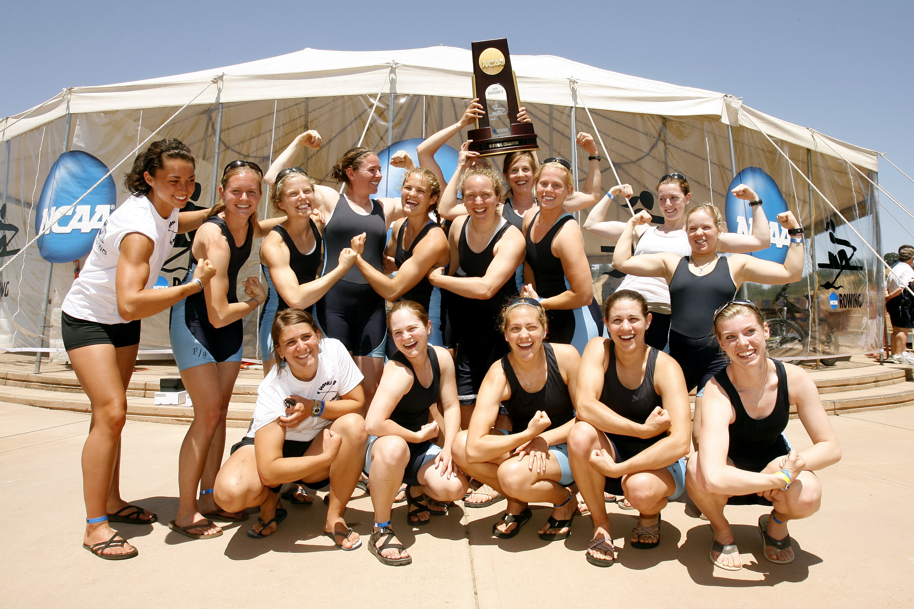 The women's rowing team flexes their arms to celebrate their 2008 national championship. 