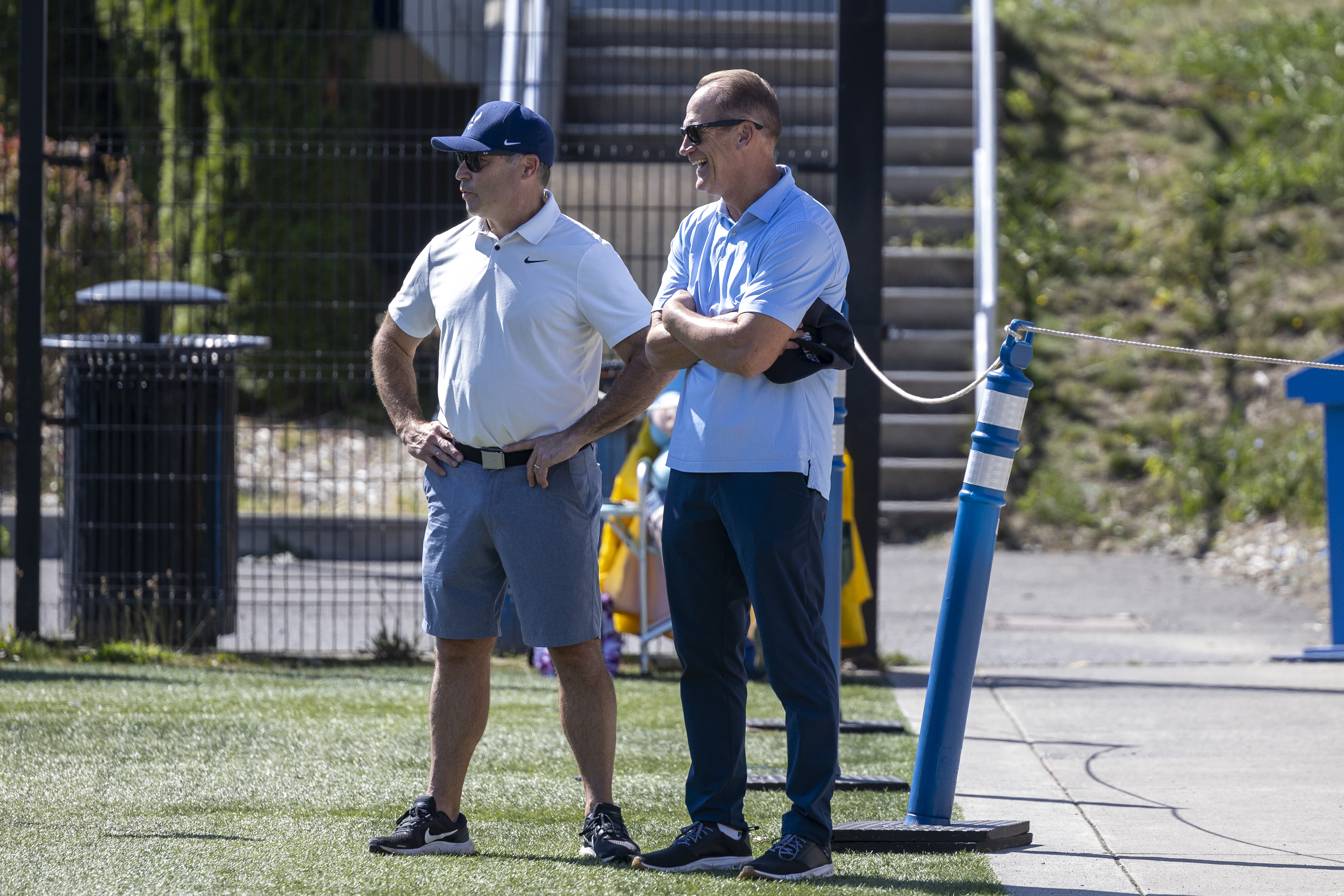 Sterk chats with Steve Brummel on the edge of a soccer field