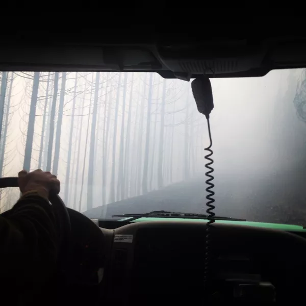 a view out a truck windshield through the smoky haze