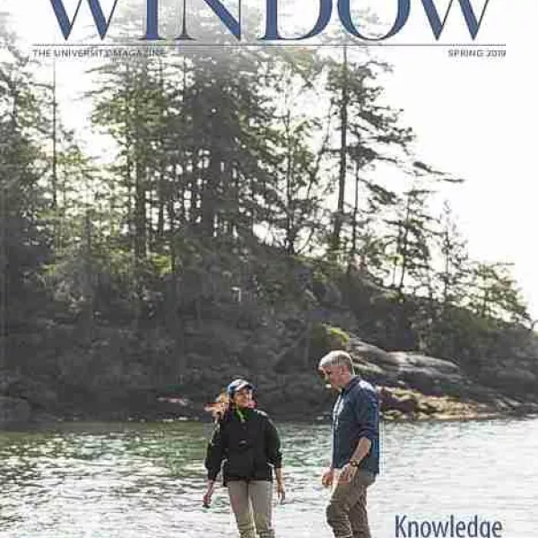 Researchers next to a river on the Spring 2019 Window cover
