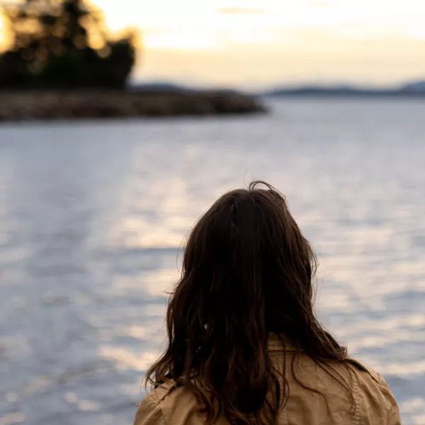 Caitlyn Blair, seen from behind, looks out at Bellingham Bay