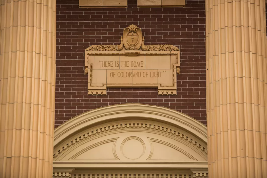a plaque above the doorway to Edens Hall, &quot;Here is the Home of Color and Light.&quot; 