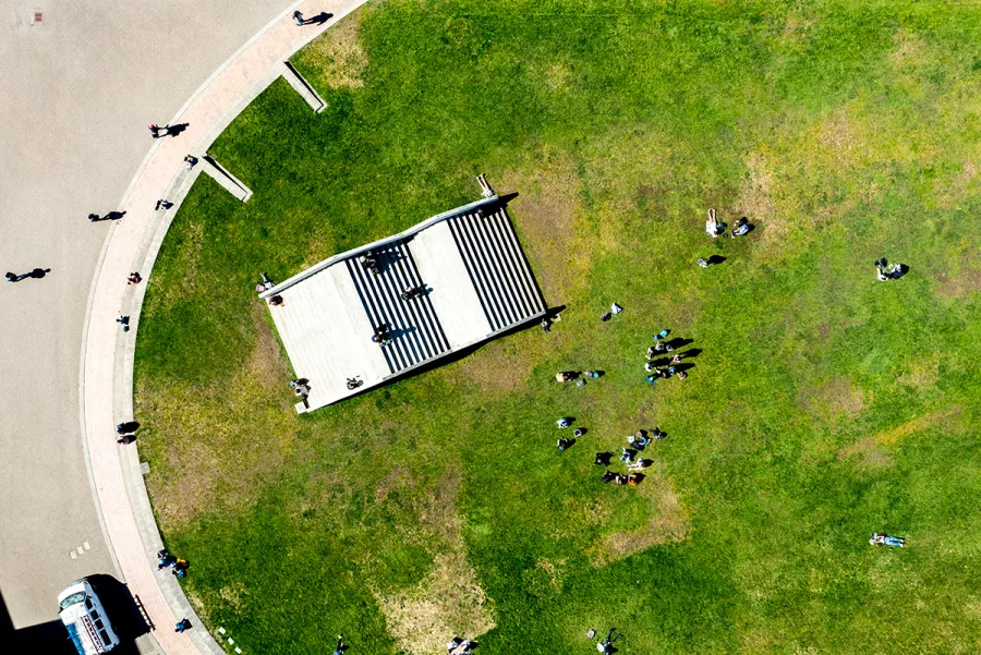 Students gather on and around Stadium Piece, as seen from above on a sunny day 