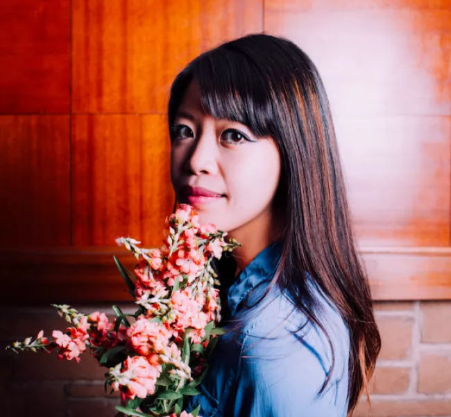 Jane Wong holds a bouquet of flowers. 